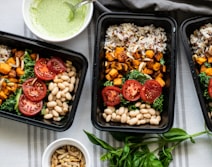 Trays of freshly prepared meals laid out for a corporate lunch service