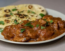 A slow-cooked curry served with fresh roti